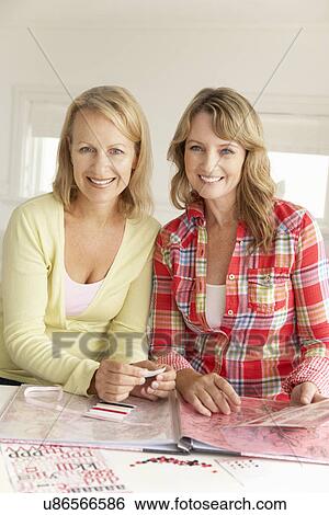 Mid age women scrapbooking View Large Photo Image Stock Photograph - Mid age women scrapbooking. Fotosearch