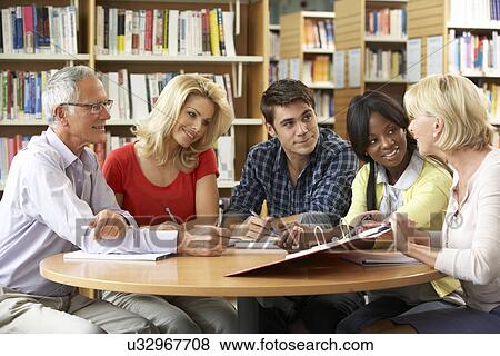 Mixed group of students in library View Large Photo Image Stock Photo - Mixed group of students in library. Fotosearch