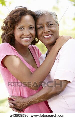 Stock Photograph - Mother and adult daughter portrait. Fotosearch