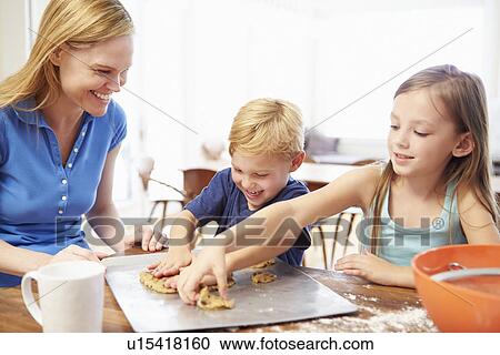 Mother And Children Baking Cookies Together At Home View Large Photo Image Stock Image - Mother And Children Baking Cookies Together At Home. Fotosearch