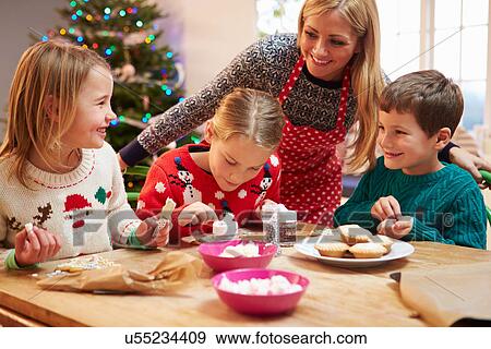 Mother And Children Decorating Christmas Cookies Together View Large Photo Image Stock Photo - Mother And Children Decorating Christmas Cookies Together. Fotosearch