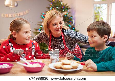 Mother And Children Decorating Christmas Cookies Together View Large Photo Image Stock Photograph - Mother And Children Decorating Christmas Cookies Together. Fotosearch