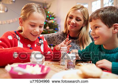 Mother And Children Decorating Christmas Cookies Together View Large Photo Image Stock Photograph - Mother And Children Decorating Christmas Cookies Together. Fotosearch