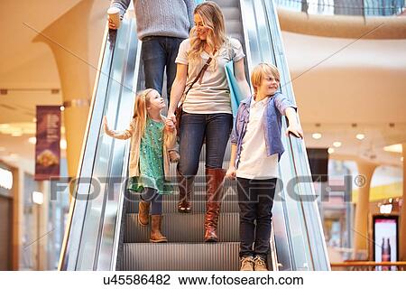Mother And Children On Escalator In Shopping Mall View Large Photo Image Stock Image - Mother And Children On Escalator In Shopping Mall. Fotosearch