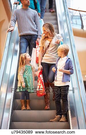 Mother And Children On Escalator In Shopping Mall View Large Photo Image Stock Photo - Mother And Children On Escalator In Shopping Mall. Fotosearch
