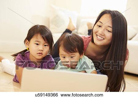 Mother And Children Using Laptop Together View Large Photo Image Stock Photograph - Mother And Children Using Laptop Together. Fotosearch