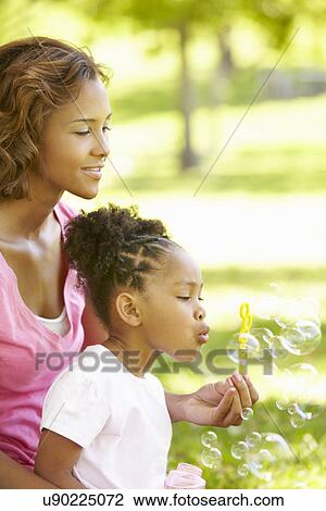 Mother and daughter blowing bubbles View Large Photo Image Stock Image - Mother and daughter blowing bubbles. Fotosearch