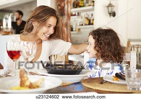 Mother And Daughter Enjoying Meal In Restaurant View Large Photo Image Stock Image - Mother And Daughter Enjoying Meal In Restaurant. Fotosearch