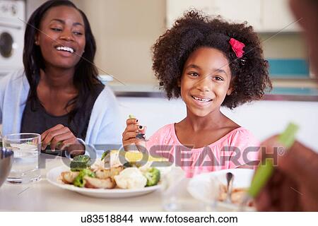 Mother And Daughter Having Family Meal At Table View Large Photo Image Picture - Mother And Daughter Having Family Meal At Table. Fotosearch