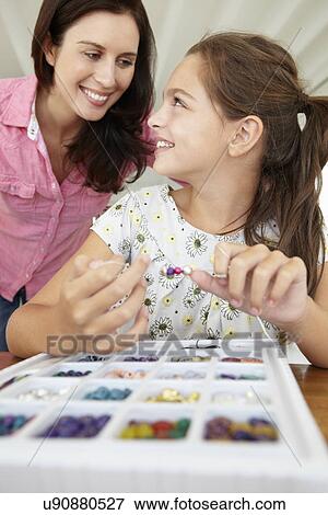 Mother and daughter making jewellery View Large Photo Image Stock Photo - Mother and daughter making jewellery. Fotosearch