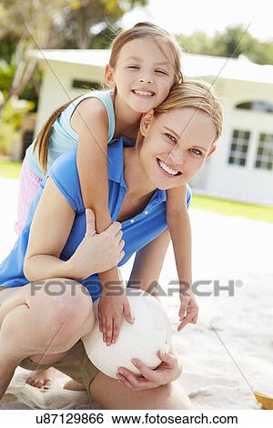 Mother And Daughter Playing Game Of Volleyball In Garden View Large Photo Image Stock Photograph - Mother And Daughter Playing Game Of Volleyball In Garden . Fotosearch