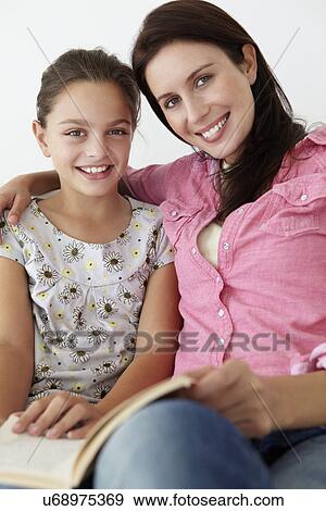 Mother and daughter reading together View Large Photo Image Stock Photo - Mother and daughter reading together. Fotosearch