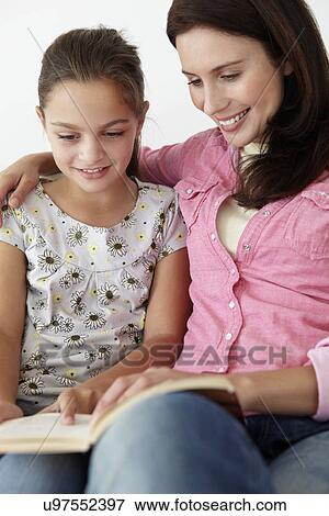 Stock Photo - Mother and daughter reading together. Fotosearch