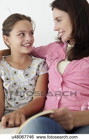 Mother and daughter reading together View Large Photo Image Stock Photograph - Mother and daughter reading together. Fotosearch