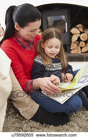 Mother And Daughter Relaxing Indoors And Reading Book View Large Photo Image Stock Photography - Mother And Daughter Relaxing Indoors And Reading Book. Fotosearch