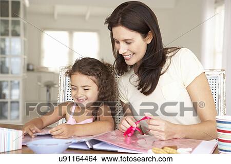 Picture - Mother and daughter scrapbooking. Fotosearch