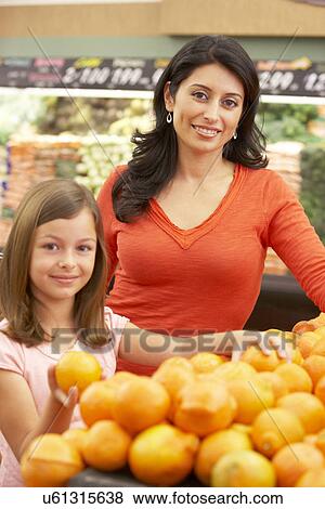 Mother and daughter shopping in supermarket View Large Photo Image Stock Photo - Mother and daughter shopping in supermarket. Fotosearch