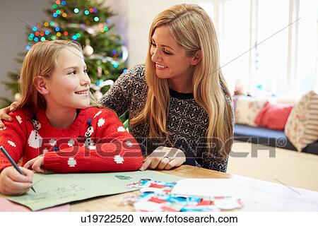 Stock Image - Mother And Daughter Writing Letter To Santa Together. Fotosearch