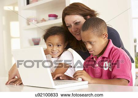 Mother and Downs Syndrome son with laptop View Large Photo Image Stock Image - Mother and Downs Syndrome son with laptop. Fotosearch
