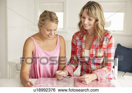 Stock Photograph - Mother and teenage daughter scrapbooking. Fotosearch