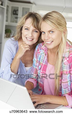 Mother and teenage daughter using laptop View Large Photo Image Stock Image - Mother and teenage daughter using laptop. Fotosearch