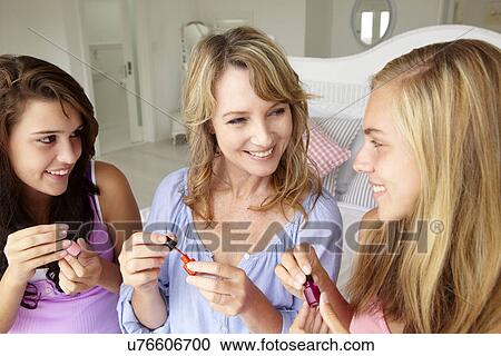 Mother and teenage daughters painting nails View Large Photo Image Stock Image - Mother and teenage daughters painting nails. Fotosearch