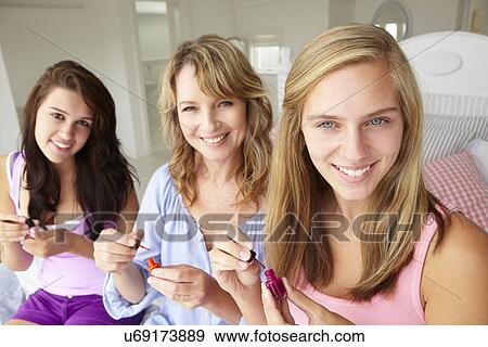 Mother and teenage daughters painting nails View Large Photo Image Stock Photo - Mother and teenage daughters painting nails. Fotosearch