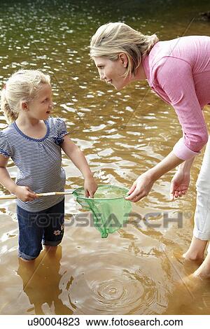 Mother and young daughter with fishing net View Large Photo Image Stock Image - Mother and young daughter with fishing net. Fotosearch