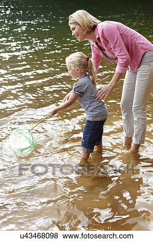 Mother and young daughter with fishing net View Large Photo Image Stock Photo - Mother and young daughter with fishing net. Fotosearch