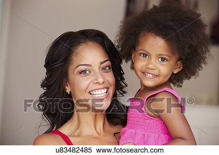 Mother Cuddling Daughter At Home View Large Photo Image Stock Photography - Mother Cuddling Daughter At Home. Fotosearch