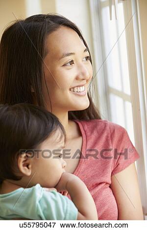 Mother Cuddling Young Son And Looking Out Of Window View Large Photo Image Stock Photo - Mother Cuddling Young Son And Looking Out Of Window. Fotosearch