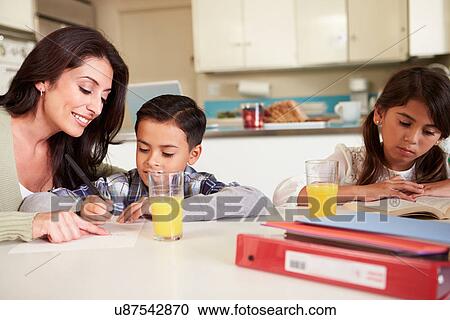 Mother Helping Children With Homework At Table View Large Photo Image Stock Image - Mother Helping Children With Homework At Table. Fotosearch