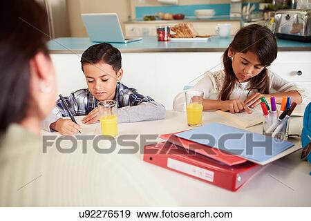 Mother Helping Children With Homework At Table View Large Photo Image Stock Photo - Mother Helping Children With Homework At Table. Fotosearch