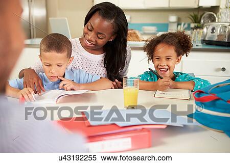 Mother Helping Children With Homework At Table View Large Photo Image Stock Photography - Mother Helping Children With Homework At Table. Fotosearch