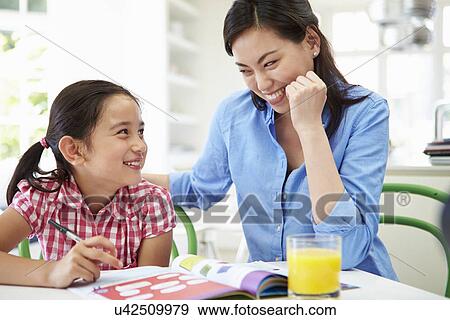 Stock Photo - Mother Helping Daughter With Homework. Fotosearch