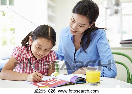 Stock Photograph - Mother Helping Daughter With Homework. Fotosearch