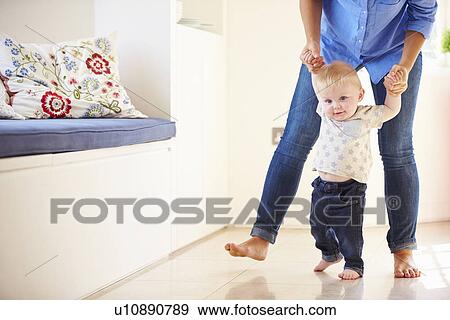 Stock Photo - Mother Helping Young Son As He Learns To Walk. Fotosearch