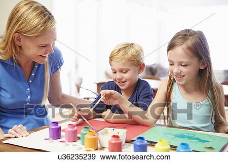 Stock Photo - Mother Painting Picture With Children At Home. Fotosearch