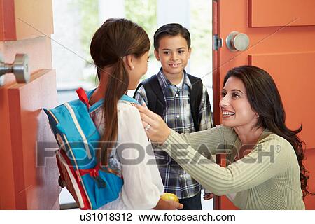 Stock Image - Mother Saying Goodbye To Children As They Leave For School. Fotosearch