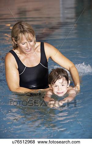 Mother teaching son to swim View Large Photo Image Stock Photo - Mother teaching son to swim. Fotosearch