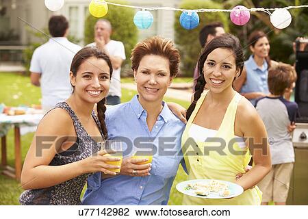 Mother With Adult Daughters Enjoying Party In Garden View Large Photo Image Stock Image - Mother With Adult Daughters Enjoying Party In Garden . Fotosearch