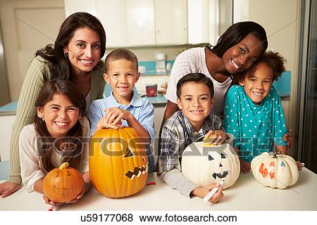 Stock Photo - Mothers And Children Making Halloween Lanterns. Fotosearch