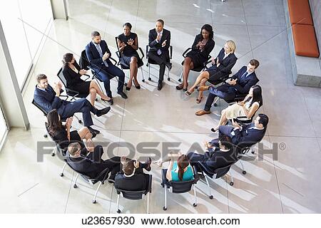 Stock Image - Multi-Cultural Office Staff Applauding During Meeting. Fotosearch