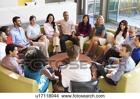 Picture - Multi-Cultural Office Staff Sitting Having Meeting Together. Fotosearch