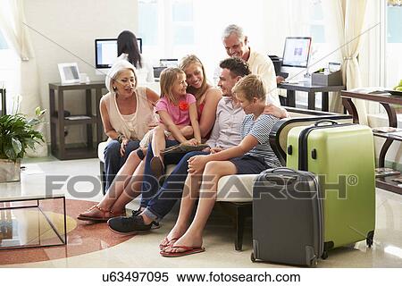 Stock Photography - Multi Generation Family Arriving In Hotel Lobby . Fotosearch