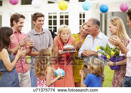 Multi Generation Family Celebrating Birthday In Garden View Large Photo Image Picture - Multi Generation Family Celebrating Birthday In Garden. Fotosearch