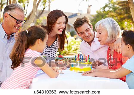 Multi-Generation Family Celebrating Birthday In Garden View Large Photo Image Stock Image - Multi-Generation Family Celebrating Birthday In Garden. Fotosearch