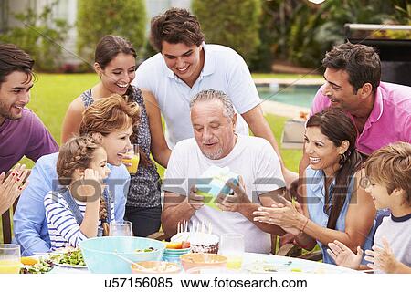 Multi Generation Family Celebrating Birthday In Garden View Large Photo Image Stock Photography - Multi Generation Family Celebrating Birthday In Garden. Fotosearch