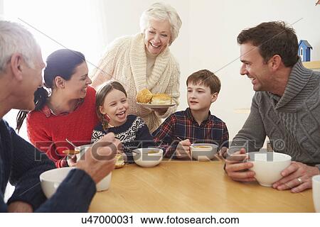 Multi Generation Family Eating Lunch At Kitchen Table View Large Photo Image Stock Image - Multi Generation Family Eating Lunch At Kitchen Table. Fotosearch