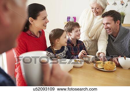 Multi Generation Family Eating Lunch At Kitchen Table View Large Photo Image Stock Photo - Multi Generation Family Eating Lunch At Kitchen Table. Fotosearch